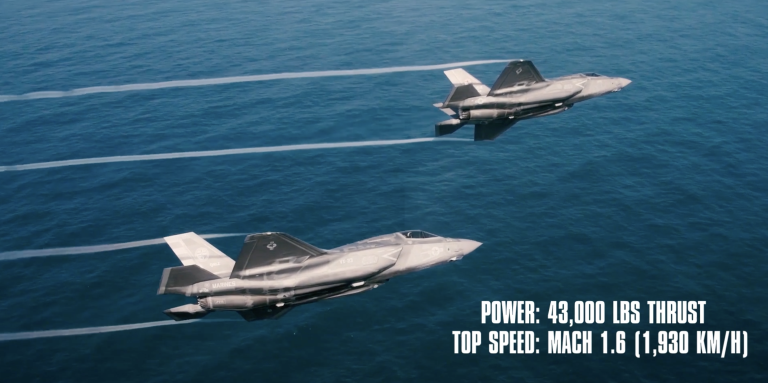 Two jets flying over water