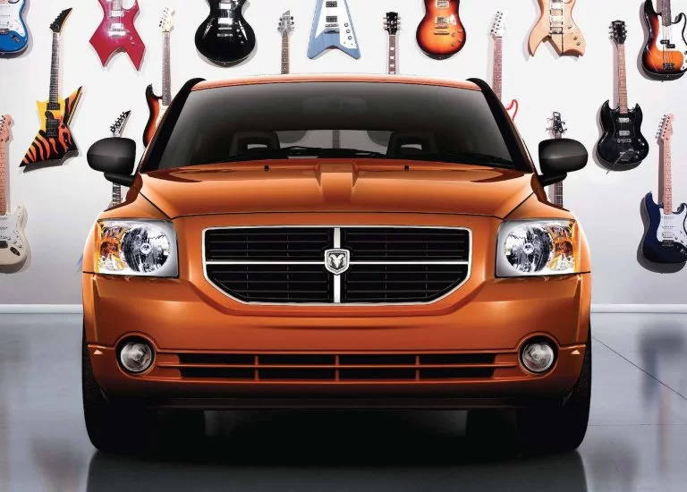 Car front of orange Jeep